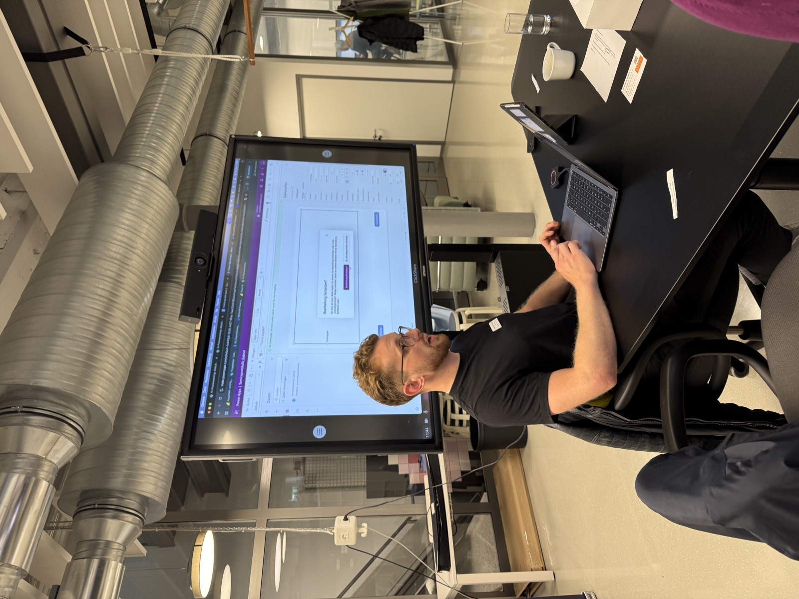 Developer working on an AI solution in front of a large screen