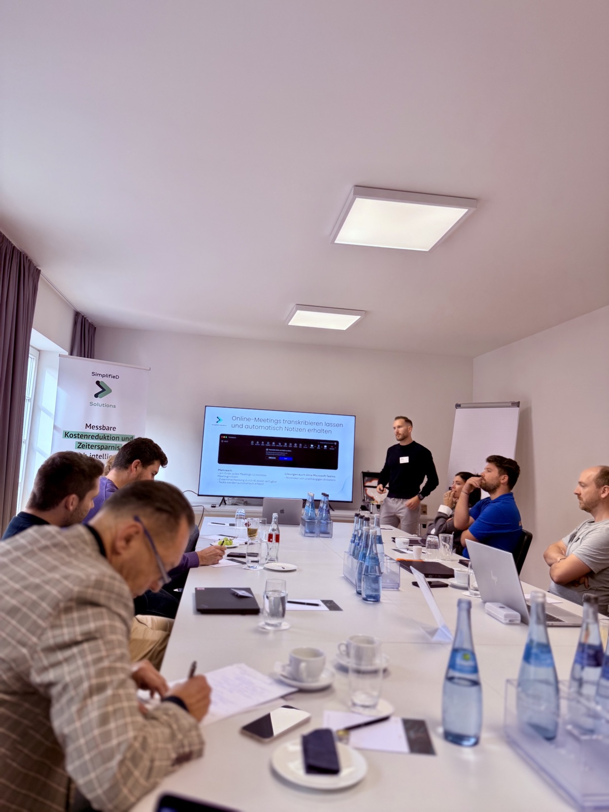 Presentation in a meeting room with SimplifieD banner